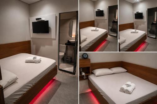 a room with two beds with a mirror and a tv at Hotel Love Augustta in São Paulo