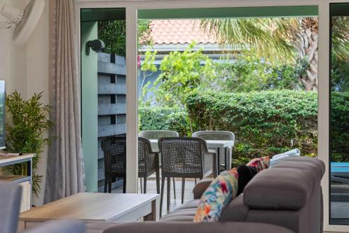 a person laying on a couch on a patio at Casa Verde - Blije Rust I in Dorp Sint Michiel