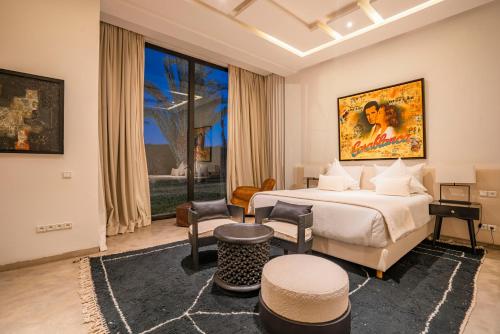 a hotel room with a bed and a large window at Luxury Marrakech Villa marrakech pool,staff,brekfast included in Marrakesh