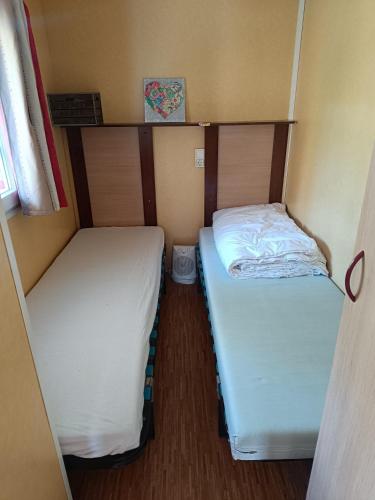 a small room with two beds in it at Mobile homes a la ferme in Ille-sur-Têt