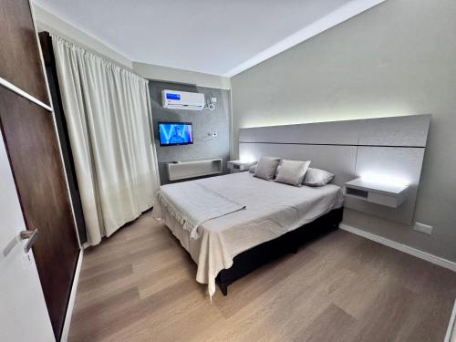 a bedroom with a bed with two pillows at Vcp urban suites in Villa Carlos Paz