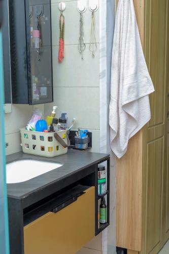 a bathroom with a sink and a mirror at Cozy Retreat in Kampala