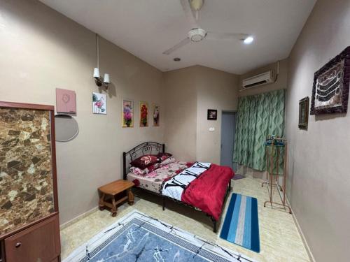 a bedroom with a bed and a rug in it at Labis Homestay Afina in Labis