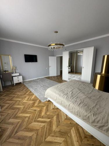 a bedroom with a large bed and a television at 14 берёз in Borovoye