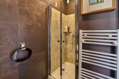 a shower with a glass door in a bathroom at A Casa Armenia B&B in Turin