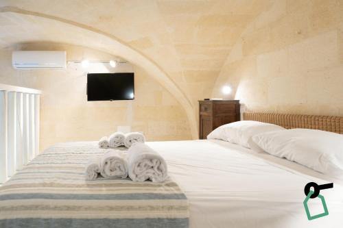 a bedroom with a bed with towels on it at Hotiday Torre Guaceto in Brindisi