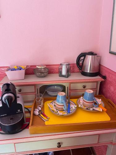 a kitchen counter with a table with dishes on it at Philippe in Beaurecueil
