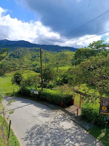 an empty road with a view of a mountain at la embajada hospedaje in San Rafael