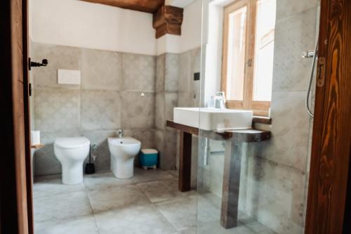 a bathroom with a sink and a toilet at borgo maira village in Prazzo