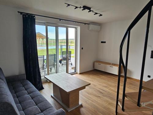 a living room with a couch and a table at Mazurska Osada in Januszkowo