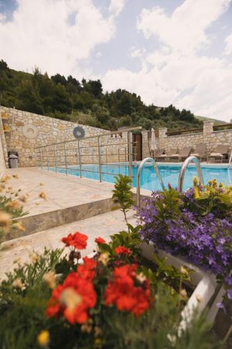 a bunch of flowers in front of a swimming pool at Vila Dena in Vlorë