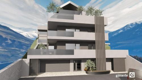a rendering of a building with mountains in the background at Augusta Apartments in Fliess