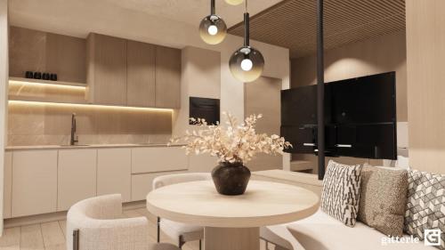 a kitchen and living room with a table and chairs at Augusta Apartments in Fliess