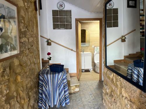 a hallway of a bathroom with a toilet and a doorway at Pé do Castelo Casinhas in Tomar