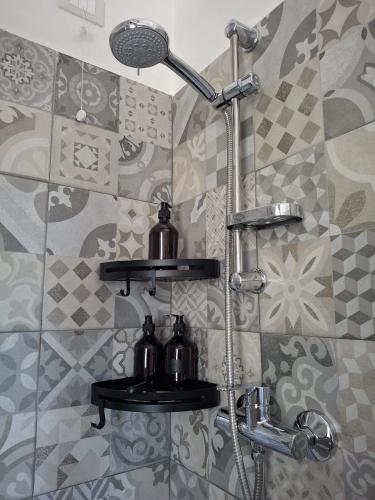 a bathroom with a shower with two tea pots at BubiBea in Silvi Marina