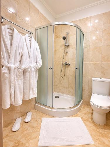 a bathroom with a shower and a toilet at Alex Hotel in Odesa