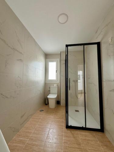 a bathroom with a shower and a toilet at Apartamentos La Janda in Benalup Casas Viejas