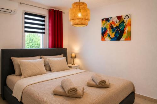 a bedroom with a large bed with two towels on it at Casa Salon T2 Centre historique Wifi Climatisation in Salon-de-Provence