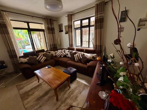 a living room with a couch and a table at Villa Luck in Trou aux Biches