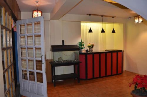 a room with a fish tank next to a door at Hotel Kalika Darjeeling in Darjeeling