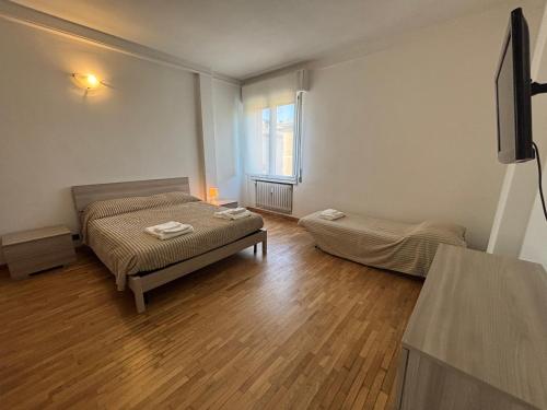 a small room with two beds and a window at Montegrappa smart stay Modena in Modena