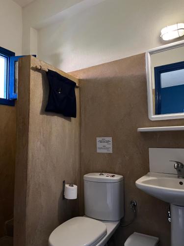 a bathroom with a toilet and a sink at Maistrali Studios Skiathos in Koukounaries