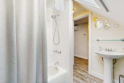 a bathroom with a shower curtain and a sink at East End Annex in Portland
