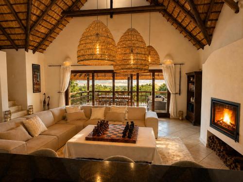 a living room with a couch and a fireplace at Amazing mountain views! Solar powered! in Hoedspruit