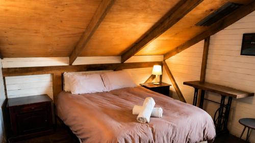 a bedroom with a bed with a teddy bear on it at Hostal Climb House in Puerto Varas