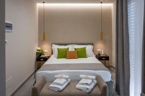 a bedroom with a large bed with green pillows at Alba Stays in Ladispoli