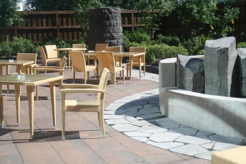 a group of tables and chairs in a patio at Hotel Reykjavík Grand in Reykjavík