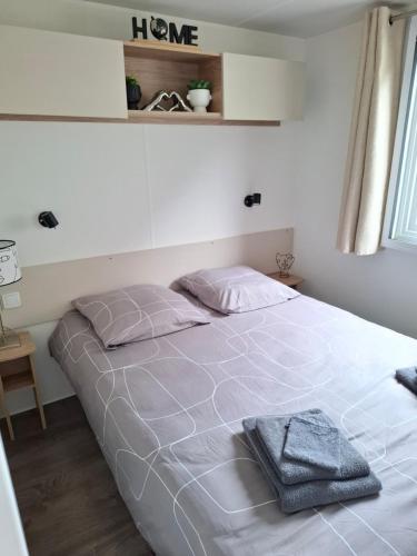 a bedroom with a bed with a white bedspread at La plage in Canet-en-Roussillon