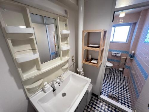 a bathroom with a sink and a toilet at 北浜 港近くの個室ステイ in Takamatsu