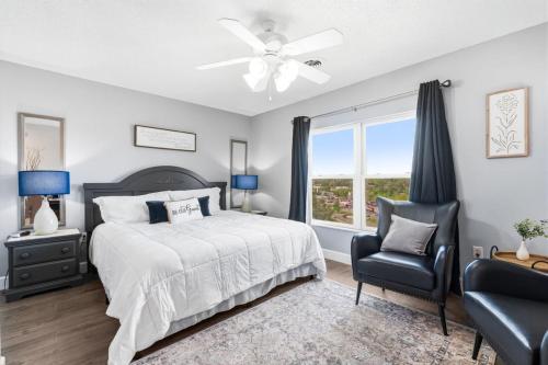a bedroom with a bed and a chair and a window at WP252 Be Our Guest in Pigeon Forge