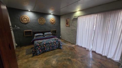 a bedroom with a bed and a large window at Vulture's View 6 in Hartbeespoort