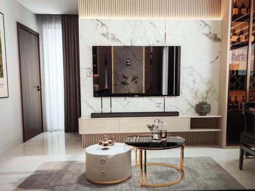 a living room with a table and a mirror at The Fermin Premium Studios in Ho Chi Minh City