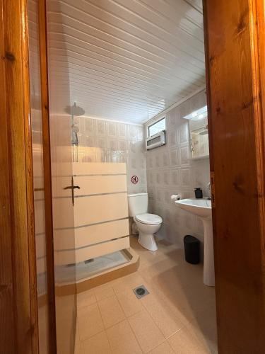 a bathroom with a toilet and a sink at The Village Studio AVLI Upper Vrasna in Nea Vrasna