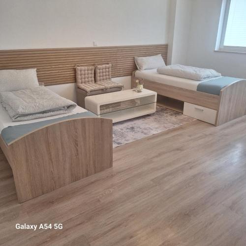 a room with two beds and a couch in it at Gasthaus Sonne 1 in Braunsbach