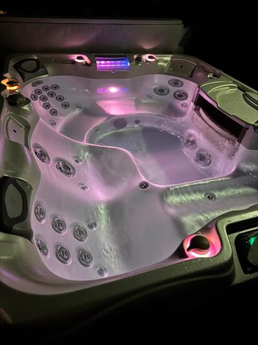 a purple bath tub with lights on it at L'écrin vert in Villelongue-dʼAude