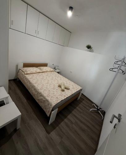 a bedroom with a bed with a cross on it at Apartment Zart 2 in Dekani