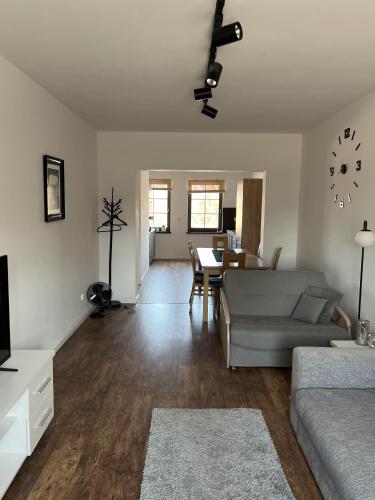 a living room with a couch and a table at Noclegi Apartamenty Sępopol in Sępopol
