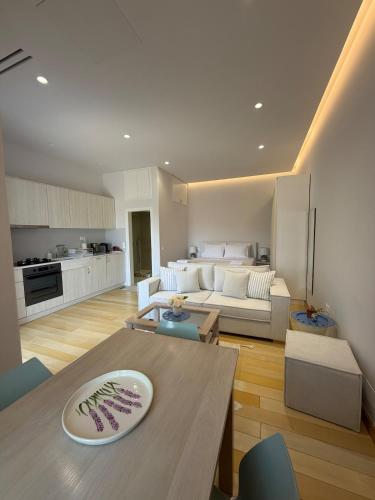 a living room with a table and a couch at Small home Pyrgos in Panormos