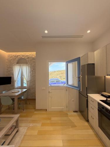 a kitchen with a table and a dining room at Small home Pyrgos in Panormos