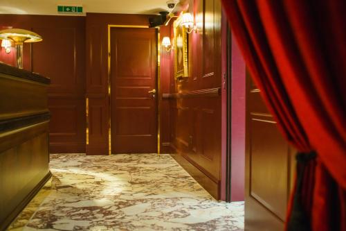 a hallway with a door and a room with a floor at Mimi's Hotel Soho in London