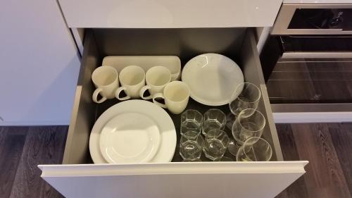 a drawer filled with dishes and glasses in a kitchen at Tehvandi Ski Apartment in Otepää