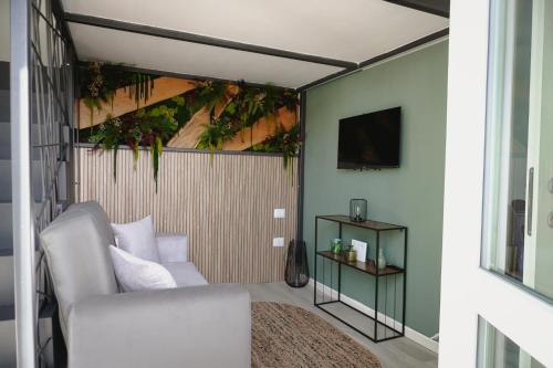 a living room with a white couch and a chair at Malpensa Elegant Loft in Gallarate