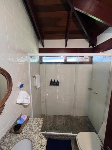 a bathroom with a shower with a toilet and a sink at Morada das marés in Angra dos Reis