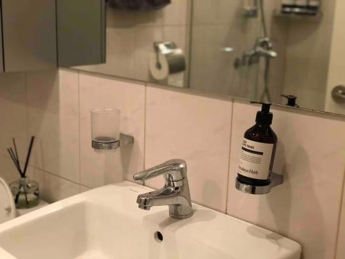 a bathroom sink with a bottle of wine on the wall at Self Check-in Only Residence near Incheon Airport T1 & Paradise City in Incheon