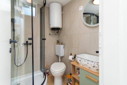 a bathroom with a shower and a toilet and a sink at Balatura House in Trogir