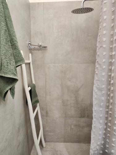 a bathroom with a shower with a shower curtain at Bianco e Rosmarino in Selva di Fasano